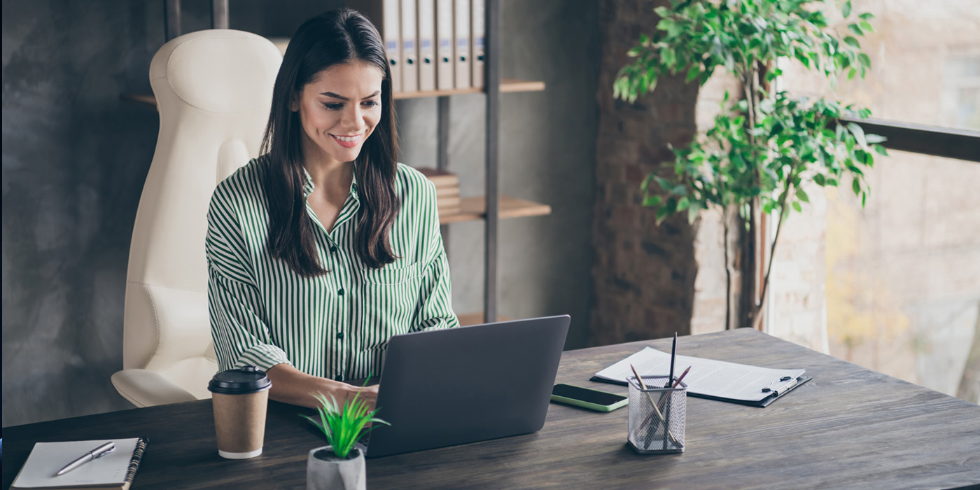 image of woman sitting at desk with laptop