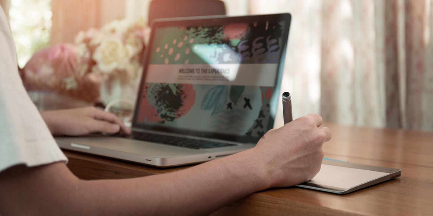 image of person sitting with computer pen & paper