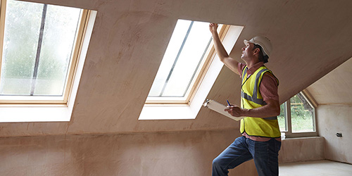 image of man inspecting around a window