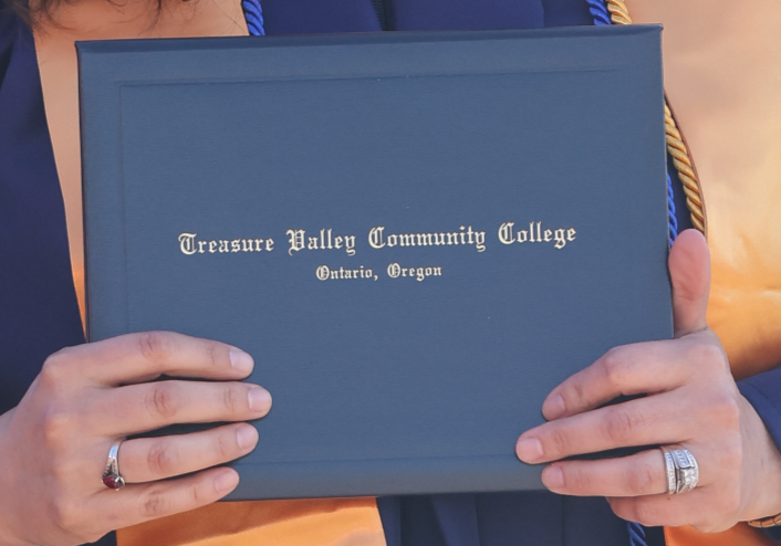 Image of a student holding a diploma