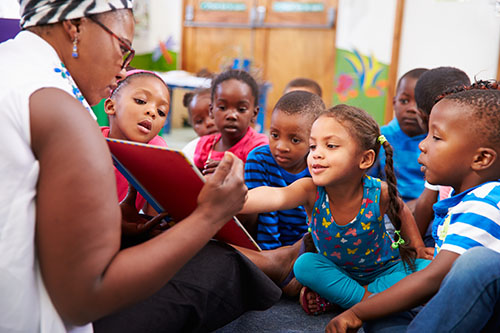 image of teacher reading to preschool children